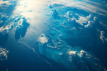 Aufkleber - The vivid image of the ocean shows clouds casting shadows on its surface, combining elements of light and darkness in a captivating natural display.
