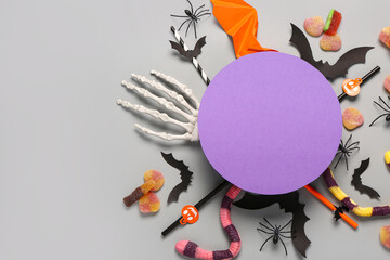 Sticker - Composition with blank card, sweet candies and Halloween decorations on grey background