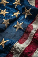 A close up view of an American flag displaying its stars and stripes on a textured fabric