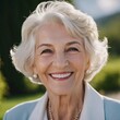 © Julija - Sophisticated smiling older French woman in the open air. Demeanor reveals a lifetime of experiences and reflections, embodying grace and wisdom. Well-groomed woman 70 years old with grey hair. AI