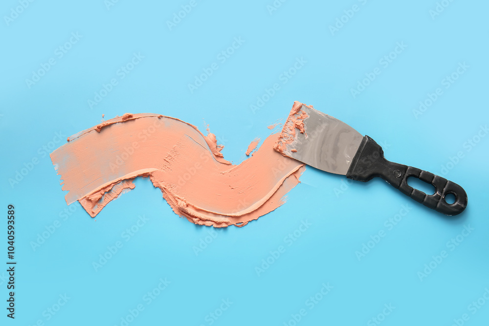 Knife with putty on blue background