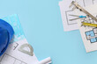 © Pixel-Shot - Frame made of architect's supplies with house plans on blue background
