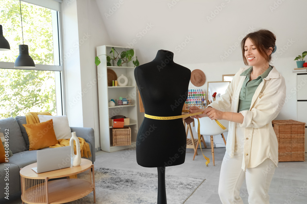 Female fashion designer measuring mannequin in studio