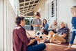 © Marko Geber - Multigenerational family playing with soccer ball on house porch