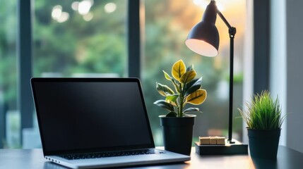 Poster - A sleek workspace with a high-tech laptop, a potted plant, and a stylish desk lamp