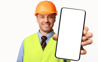 Building Services. Construction Worker Showing Cellphone Empty Screen Smiling To Camera Standing On White Studio Background. Selective Focus, Mockup