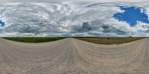 Wall Mural - 360 hdri panorama on roadside of gravel road with rain storm clouds in thunderstorm front dark sky i