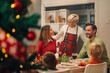 © Zamrznuti tonovi - Happy family enjoying christmas dinner together at home