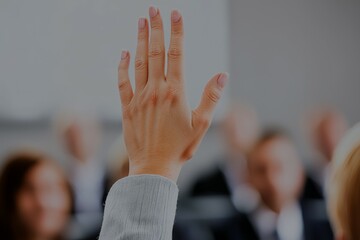 Canvas Print - A hand is raised in the air in front of a group of people