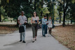 © qunica.com - Group of business people engaged in conversation while walking through a scenic park. They exhibit relaxed body language, creating a sense of open communication and teamwork in an outdoor environment.
