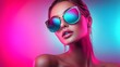 © Todd's Studio - Close-up of a fashion model wearing blue sunglasses, against a pink background with neon lights.