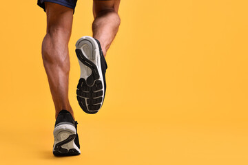 Wall Mural - Man running on orange background, closeup. Space for text