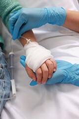 Wall Mural - Doctor and child with IV drip in hospital, closeup