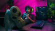 © Yuliia - Indian American man gamer gambler computer game technology mobile phone smartphone pc addiction pause network keyboard excited male mouse put feet table gadgets guy stuck connection cyber electronic