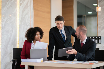 Diverse business team discussing project at office desk, Concept of teamwork