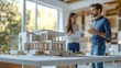 © Luxetify - White architectural model of a modern home on a table with two people blurred in the background.