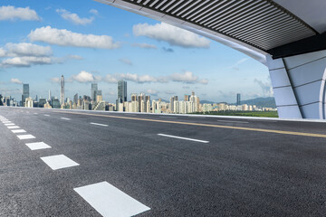 Wall Mural - Asphalt highway road and bridge with modern city buildings scenery in Shenzhen. car advertising background.