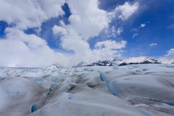 Stunning glacier landscape with blue sky and clouds.