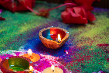 Clay diya lamps lit during diwali celebration. Indian festival Diwali, Diya oil lamps lit on colorful rangoli. Hindu traditional.