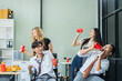 © NINENII - Asian business team are excited business success with inspiration from their excellent financial results, celebration successful deal with champagne and pizza in the workplace.
