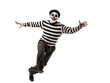 © Thak Pixel - mime performing a funny routine walking against the wind in black and white striped costume on isolated background