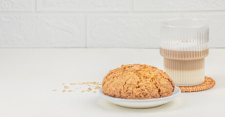 oatmeal cookies with with a glass of latte on a light background, copy space