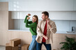 © DimaBerlin - Happy couple dancing back to back, celebrating housewarming, moving into new home, ready to unpacking. Beginnings of family, mortgage journey, homeownership, shared dreams, new beginnings as landlords