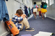 © Rido - Schoolboy crying on floor after suffering an act of bullying