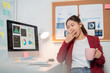© Tj - Young businesswoman is yawning and holding a cup of coffee in her office, feeling tired and sleepy while working on a data analysis project