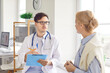 © Studio Romantic - Young male doctor wearing white medical uniform consulting female patient, talking on consultation during modern clinic visit, discussing checkup results with woman client at meeting in hospital