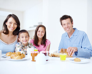 Family, portrait and morning for breakfast in home, dining table and support with eating healthy food. Parents, kids and talking together in kitchen with meal, love and brunch nutrition for bonding