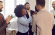 © Studio Romantic - African american businesswoman clapping shoulder of businessman. Group of multicultural business people congratulating colleague clapping hands. Concept entrepreneur startup, company celebration