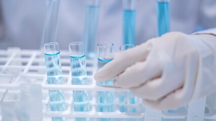 Closeup test tube equipment filling with blue liquid in laboratory room use for science chemistry biology biotechnology medical medicine biochemistry research and development discovery education