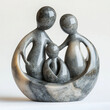 © Chanyapat - A beautiful soapstone carving depicting family of three, showcasing mother, father, and child in loving embrace. smooth texture and elegant design evoke warmth and togetherness