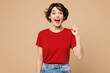 © ViDi Studio - Young smart proactive happy woman she wears red t-shirt casual clothes holding index finger up with great new idea isolated on plain pastel light beige background studio portrait. Lifestyle concept.