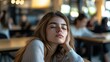© MetaPixel - Exhausted young female student dozing off during class at an educational institution