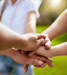© peopleimages.com - Hand stack, family and parents with children outdoor for team building, support and vacation celebration. People, palm and circle with game agreement, partnership and summer community of park bonding