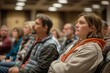© YURY YUTY - Focused audience members at a conference listening intently.
