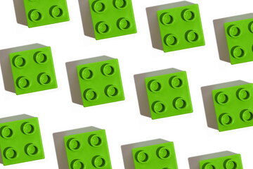 Pattern of many green plastic building block toy for constructor on white isolated background. The concept of children's educational games. Image for your design