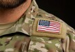 © Tuong - US Military Uniform with American Flag Patch on Shoulder - Closeup Shot with Blurred Background and Copy Space - High Quality Image