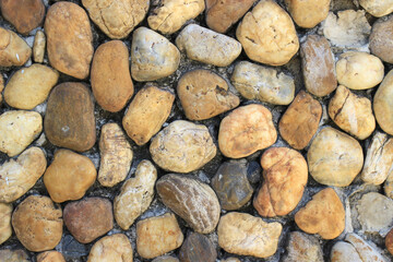 a wall decorated with large stones.