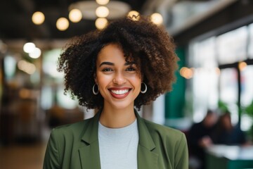 Wall Mural - Smiling portrait of a young African American businesswoman in office