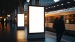 © songpol152 - Mockup. Lightbox vertical billboard with blank digital screen on a train station. white blank poster advertisement Public information boards stand at stations in front of people and trains.