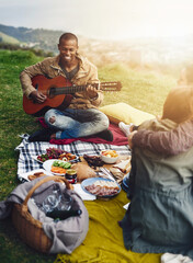 Wall Mural - Happy, picnic and friends in nature with guitar on holiday, vacation and adventure outdoors. Travel, camping and men and women with acoustic instrument for music for bonding, relax and fun on weekend