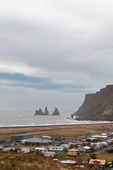 Wall Mural - Reynisdrangar basalt sea stacks - view from Vik village