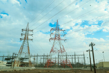 Electric towers and infrastructure in Oman under a cloudy sky during the day