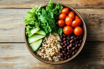 Wall Mural - Buddha bowl is sitting on a wooden table presenting plant based food with quinoa, black beans and vegetables