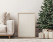 © Iryna - A blank frame for wall art mockup beside a cozy sofa and a beautifully decorated Christmas tree with gifts under it in a boho living room setting