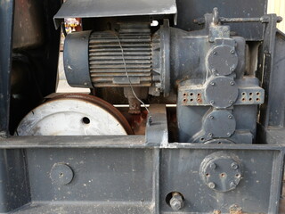 Photo detail of the engine block of the old harbor crane in Sassnitz. It is a historical masterpiece of ancient engineering.