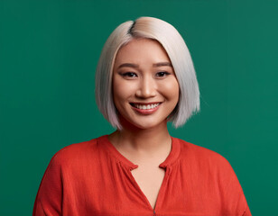 Wall Mural - Portrait of Beautiful Young Woman Happily Smiling Against Studio Background